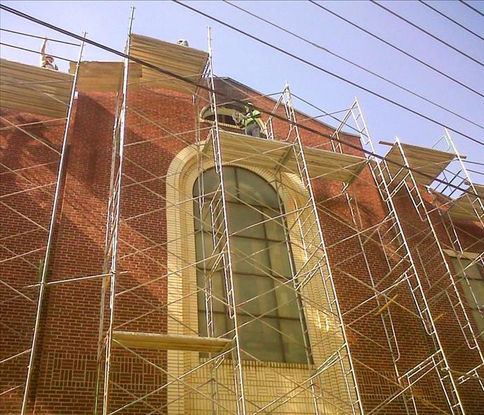 Scaffolding setup on the outside of a water damaged church in Marion, NC