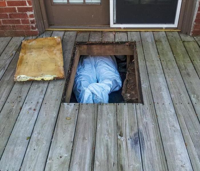 Person getting inside a crawlspace