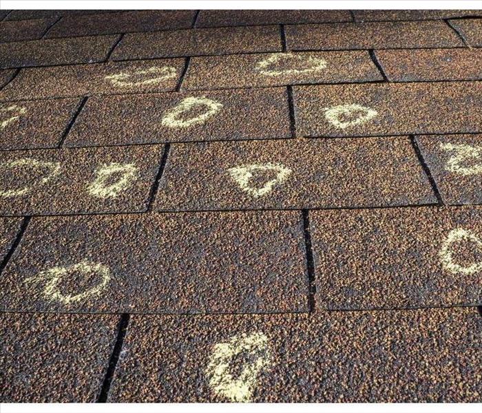Circles on a roof with chalk, hail damage on a roof